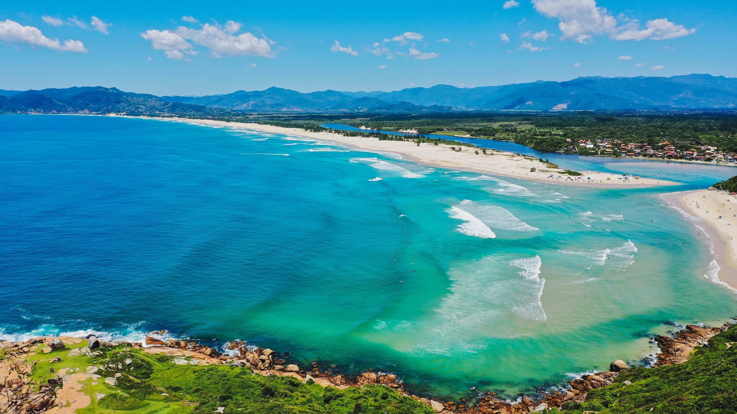 Vista aérea da Guarda do Embaú: o mar, a praia, o rio e os morros ao fundo